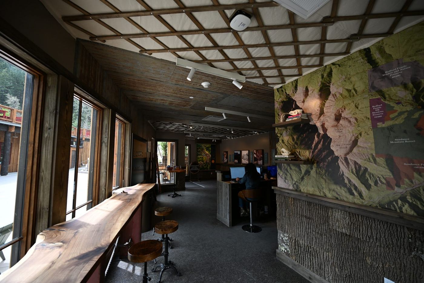 Activities center interior with live-edge counters and a mural wall