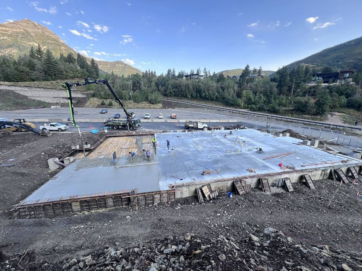 Pyne crew on a concrete foundation pour beneath the mountains