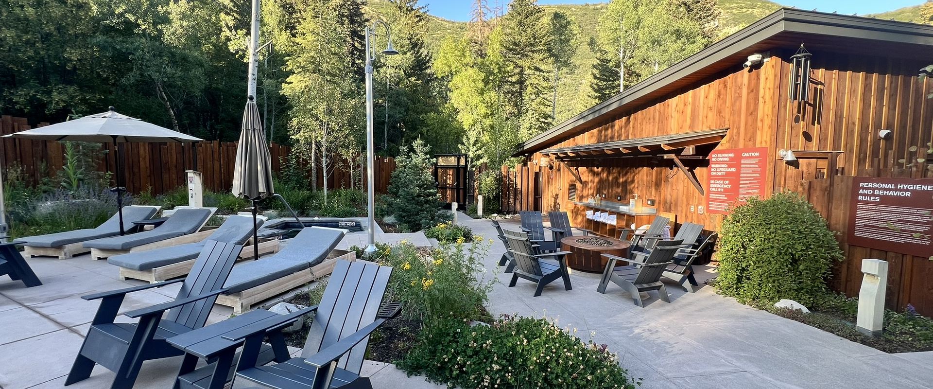 Patio seating in front of a mountain lodge