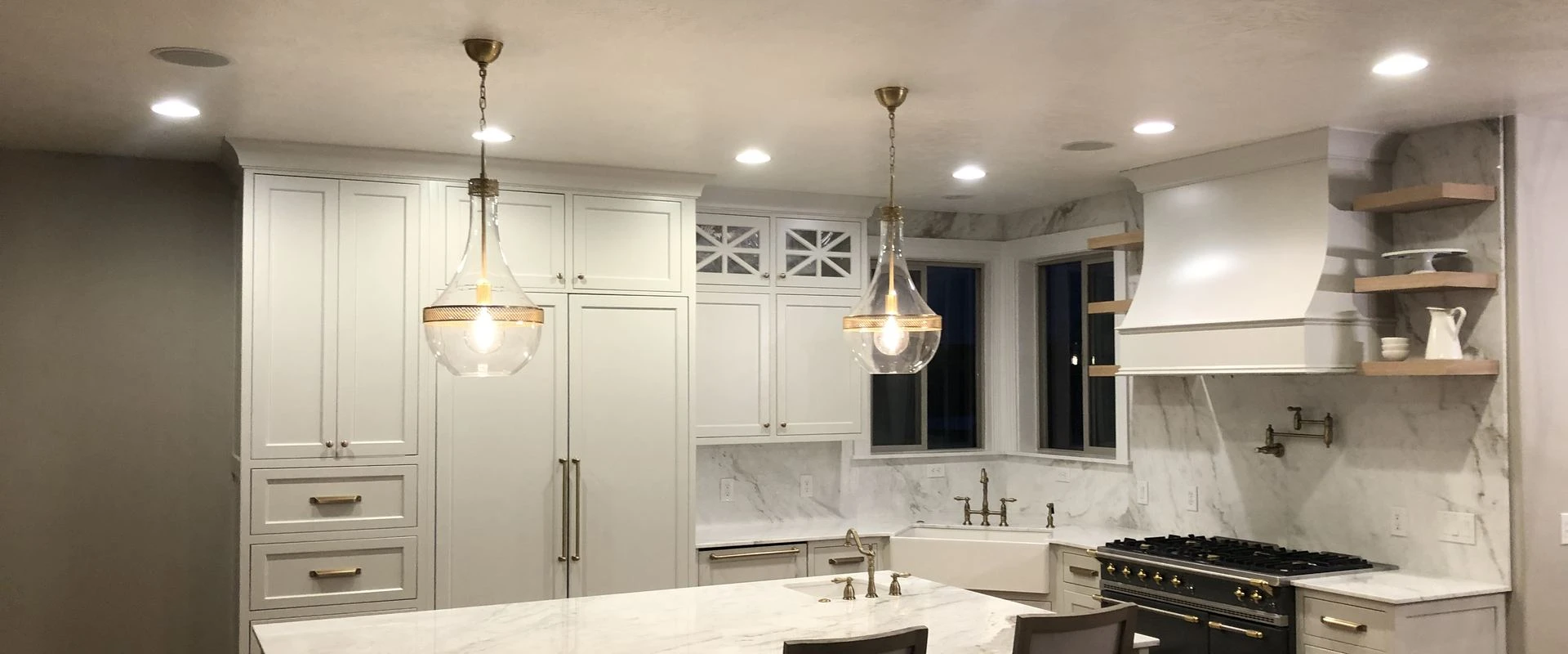 Remodeled kitchen with marble island and pendant lights