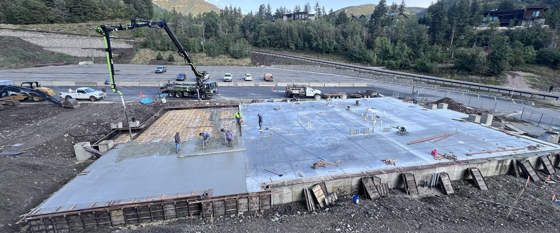 Pyne crew on a concrete foundation pour beneath the mountains