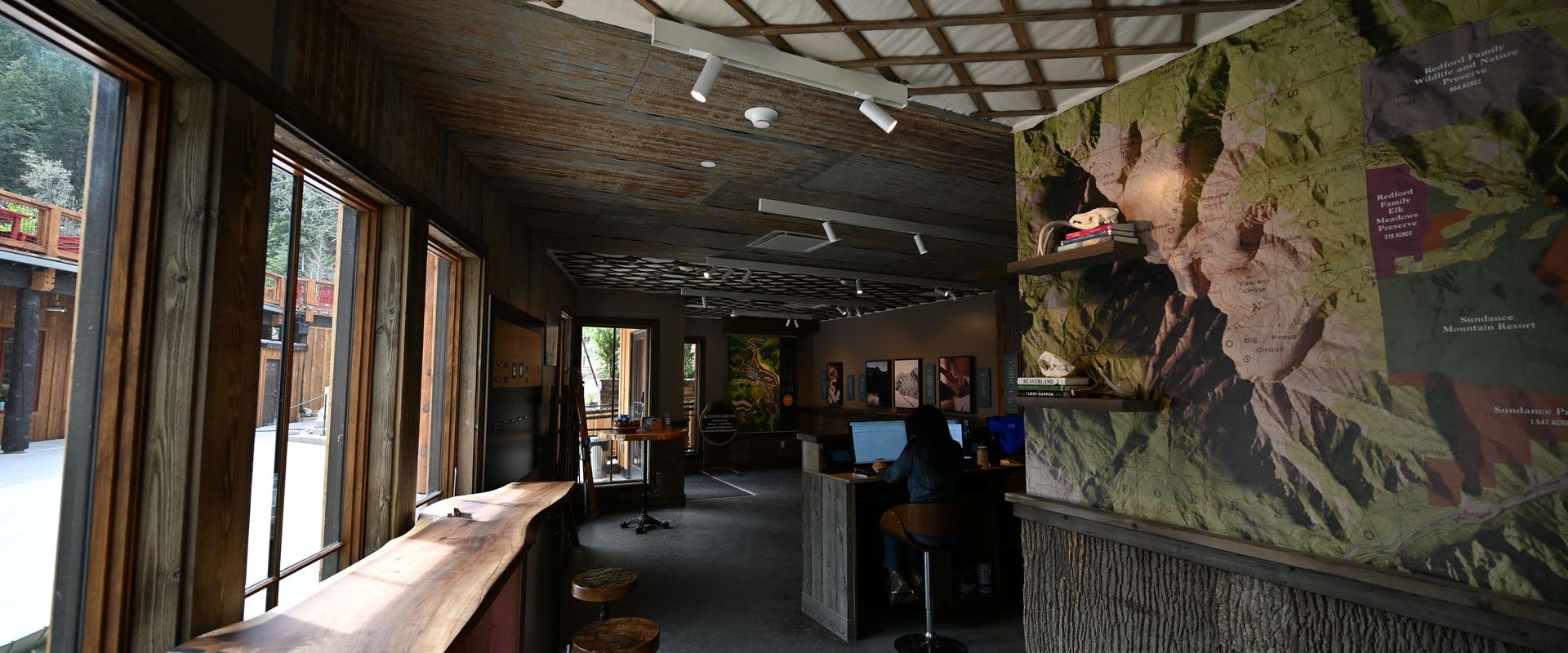 Activities center interior with live-edge counters and mural
