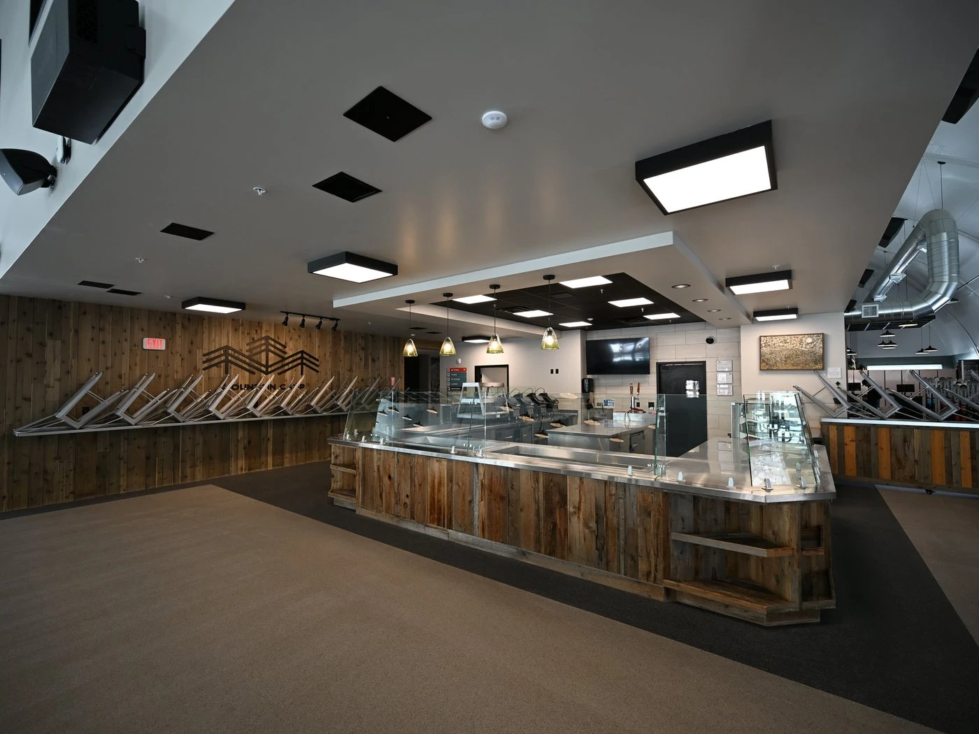 Renovated resort cafeteria with rustic wood counters and modern lighting