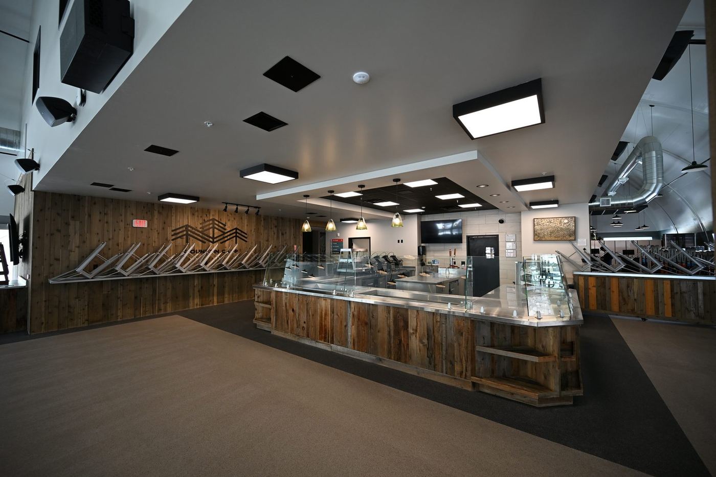 Renovated resort cafeteria with rustic wood counters and modern lighting