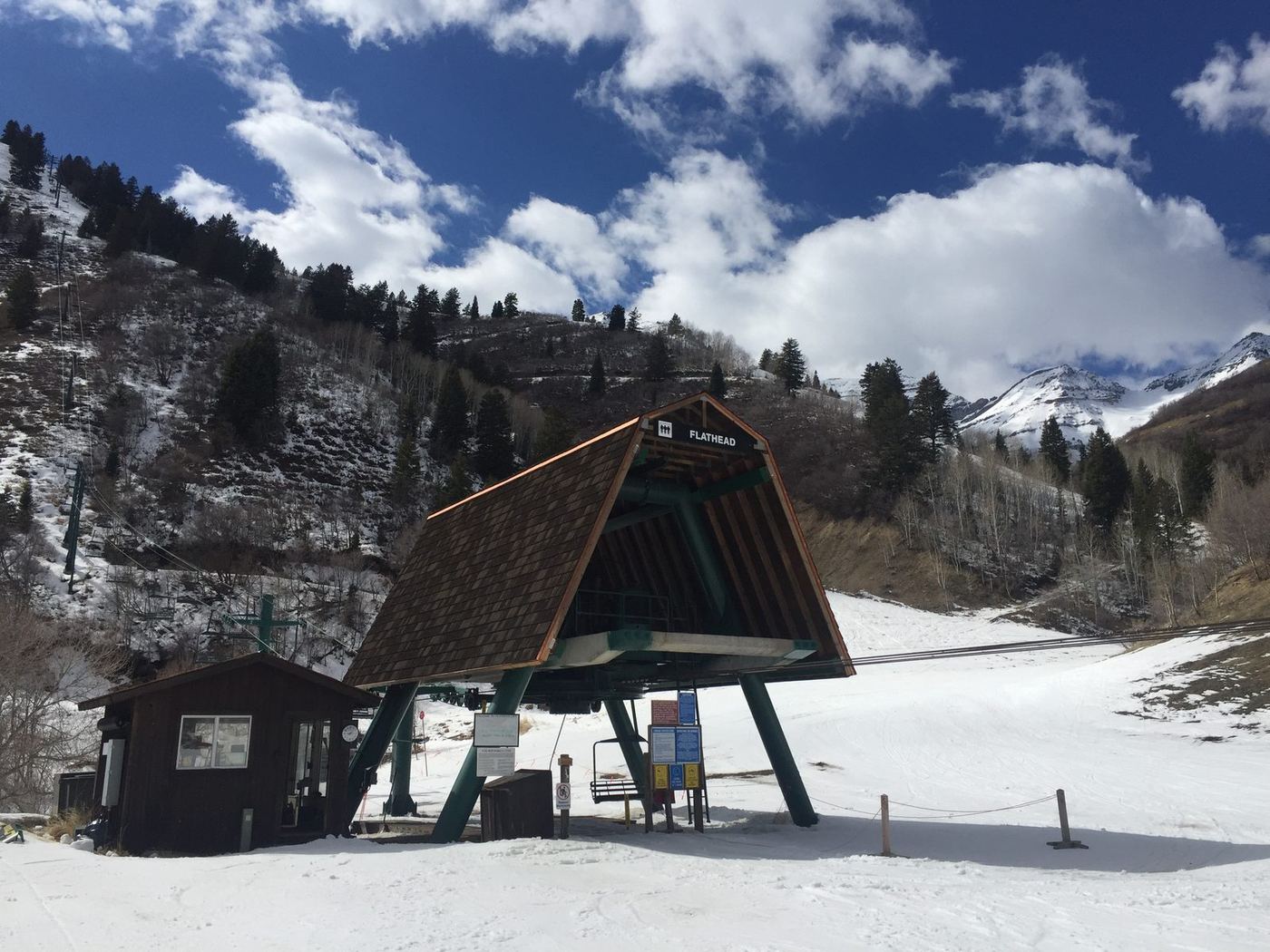 Ski lift operator hut on the slope with mountains behind