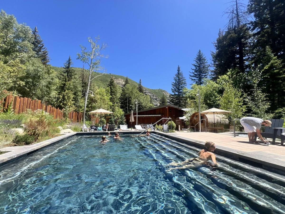 Finished pool with swimmers on a sunny day
